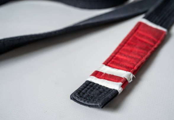 Black brazilian jiu jitsu bjj belt on the floor on the tatami in gym